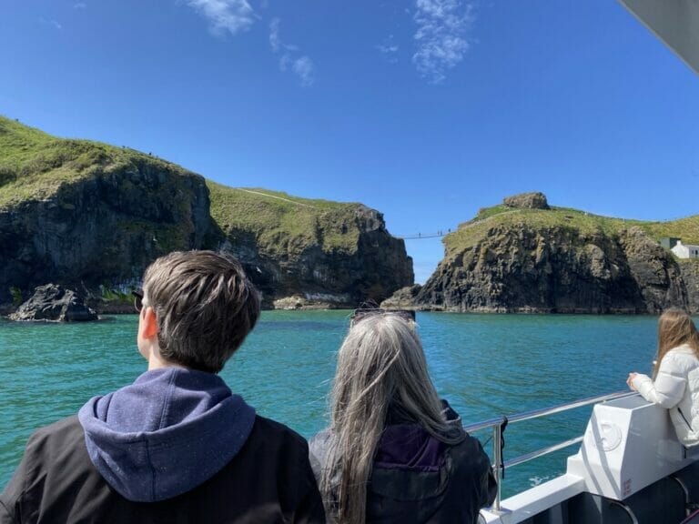 People enjoying a boat tour on a sunny day in Co. Antrim